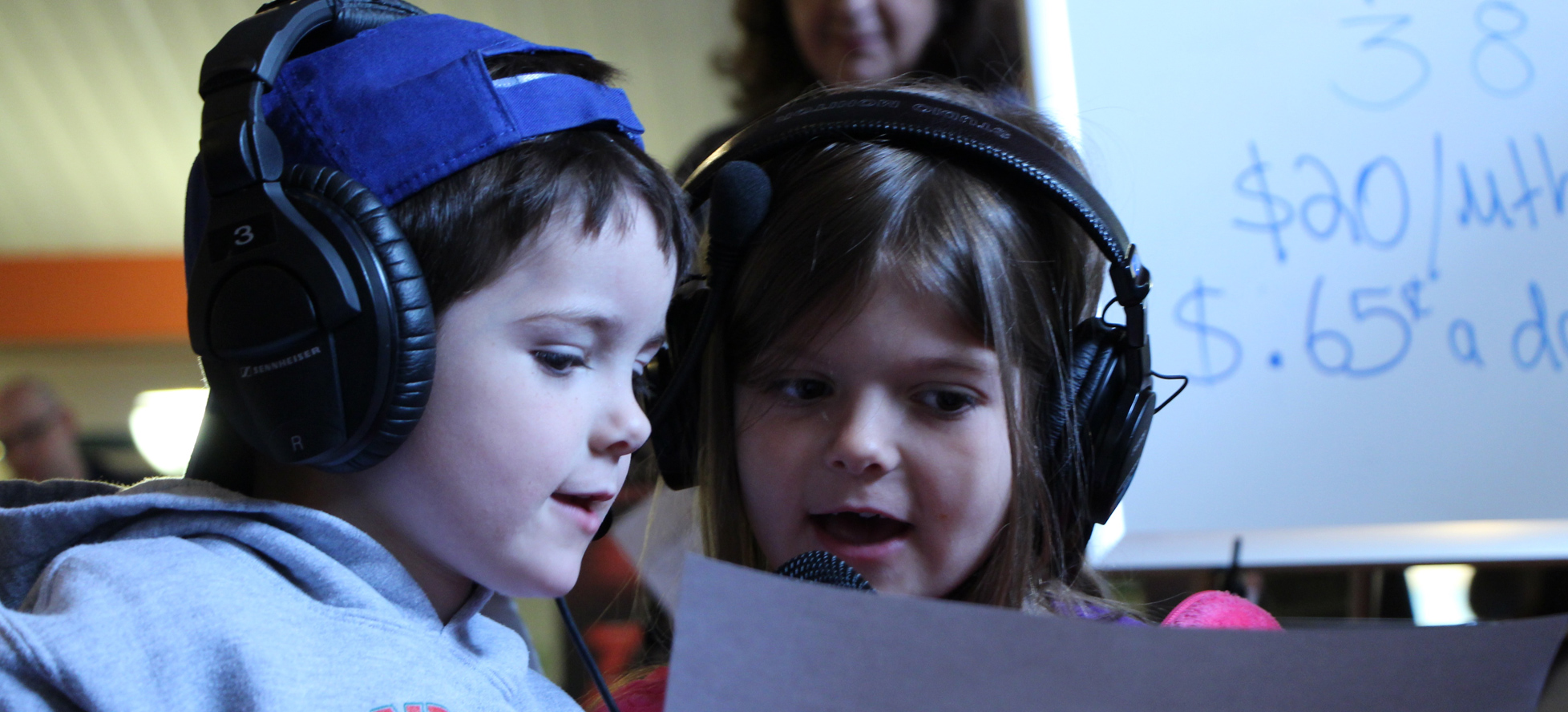 Two kids with big headphones on