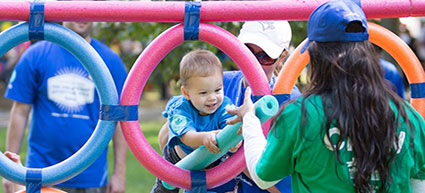 Child in a pool noodle tunnel