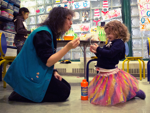 little girl with tutu blowing bubbles