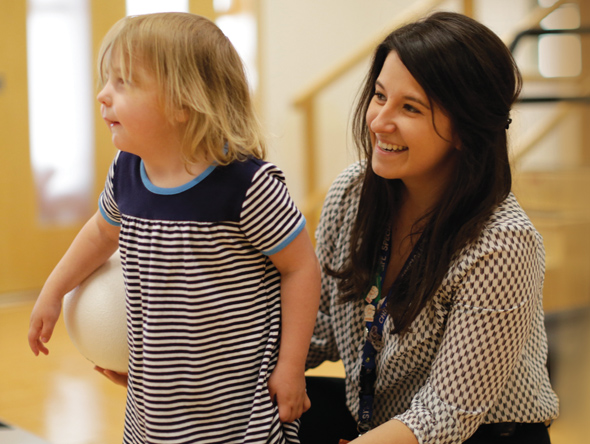 little girl with SickKids staff member
