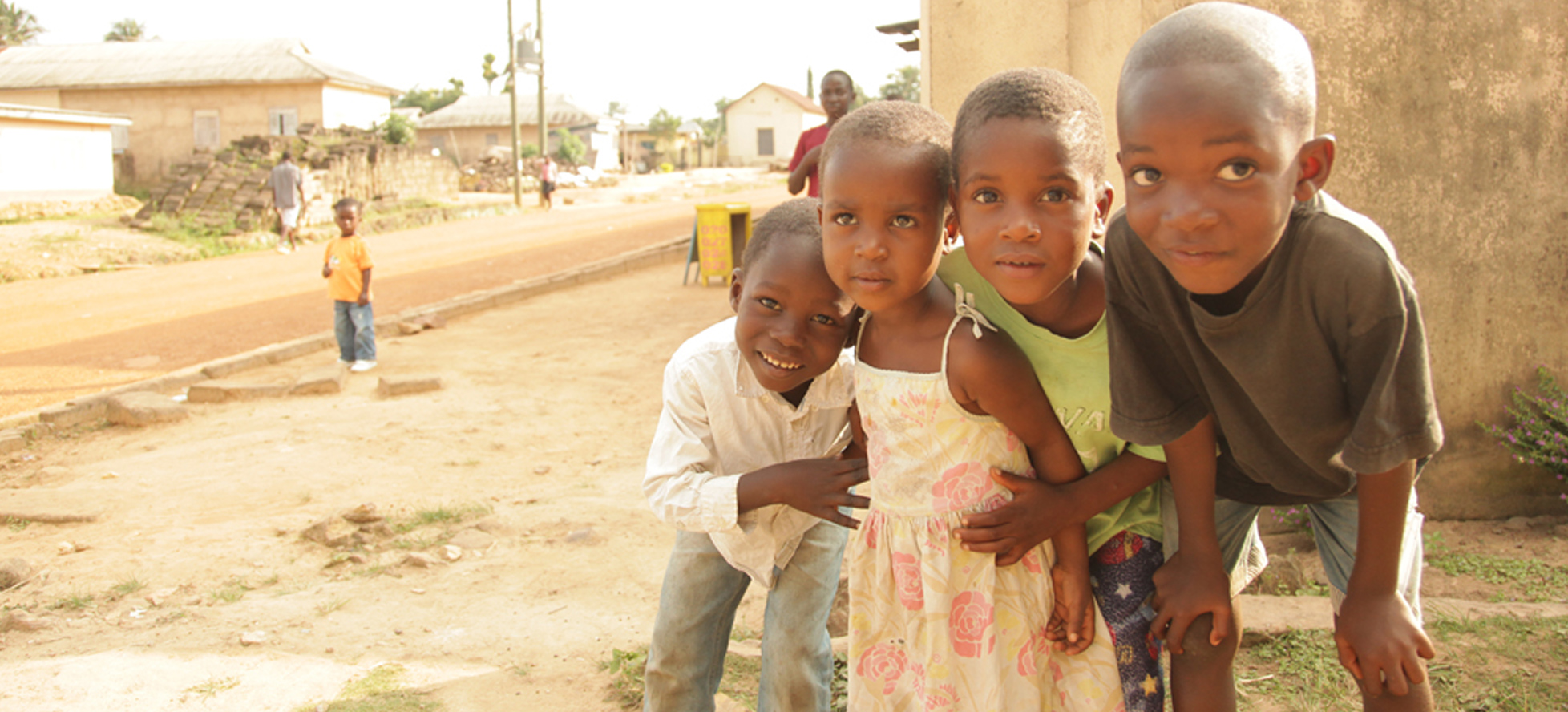 Global Child Health program, 4 kids with hands on knees