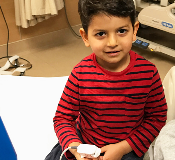 A photo of Simon smiling during a check-up at SickKids