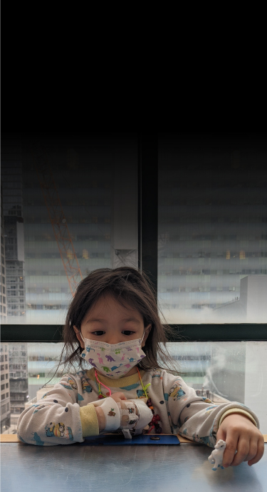 SickKids patient Elliana playing with a toy at the hospital.