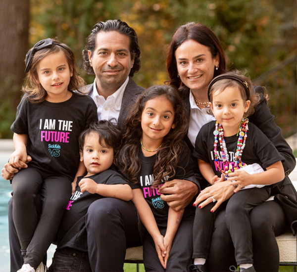  Moez and Marissa Kassam with their four beautiful children smiling.