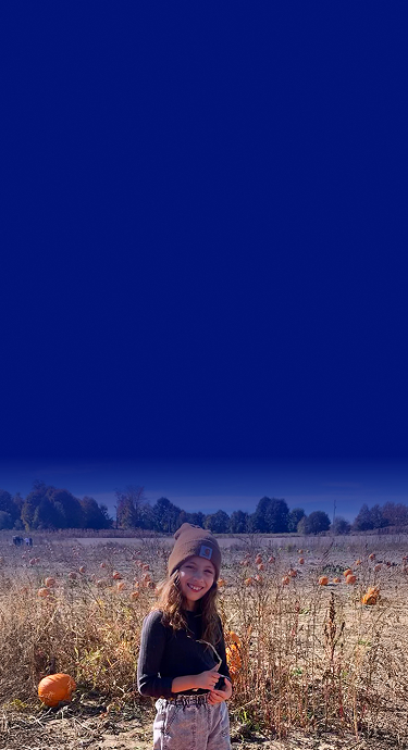 Rian in a pumpkin field