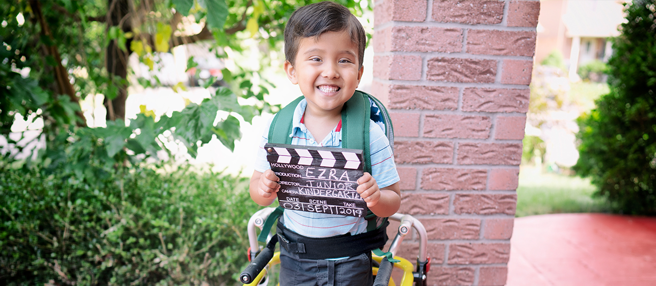 Ezra smiling on his first day of school