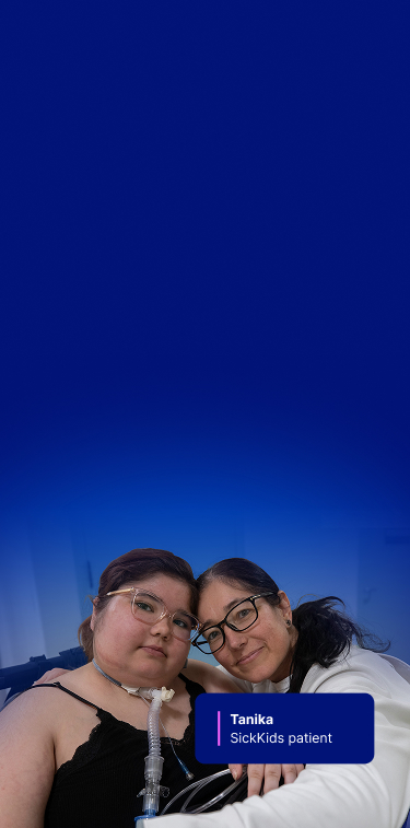 Tanika at SickKids, sitting with her mother beside her, both looking at the camera.