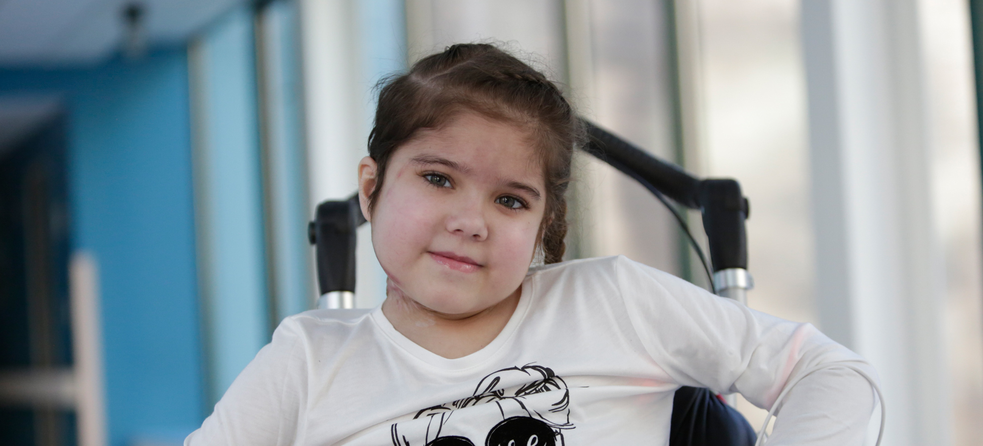 little girl sitting in wheelchair