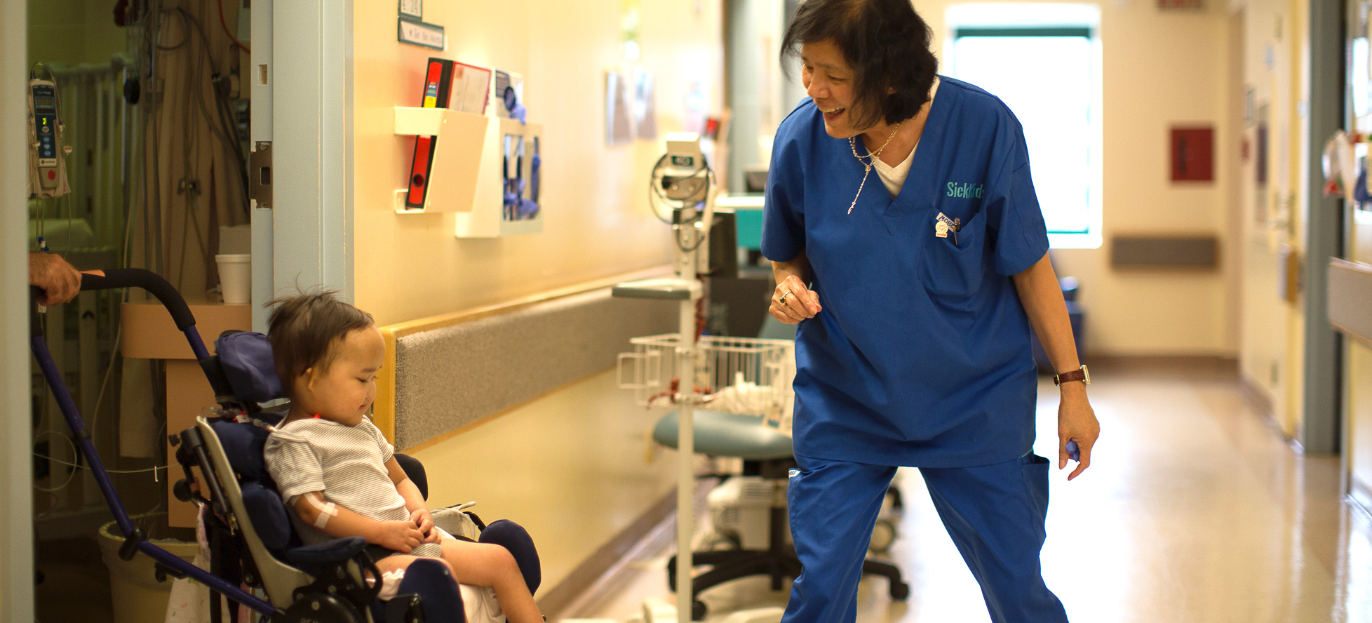 SickKids nurse with little girl in wheelchair