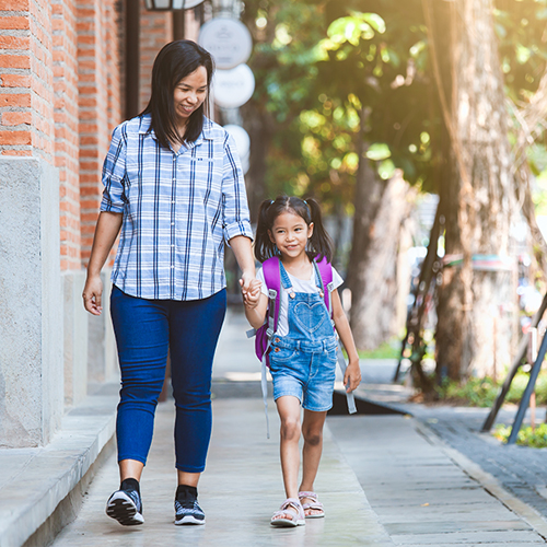 Mother and Daughter walking hand in hand