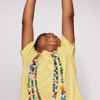 SickKids patient with hands in the air