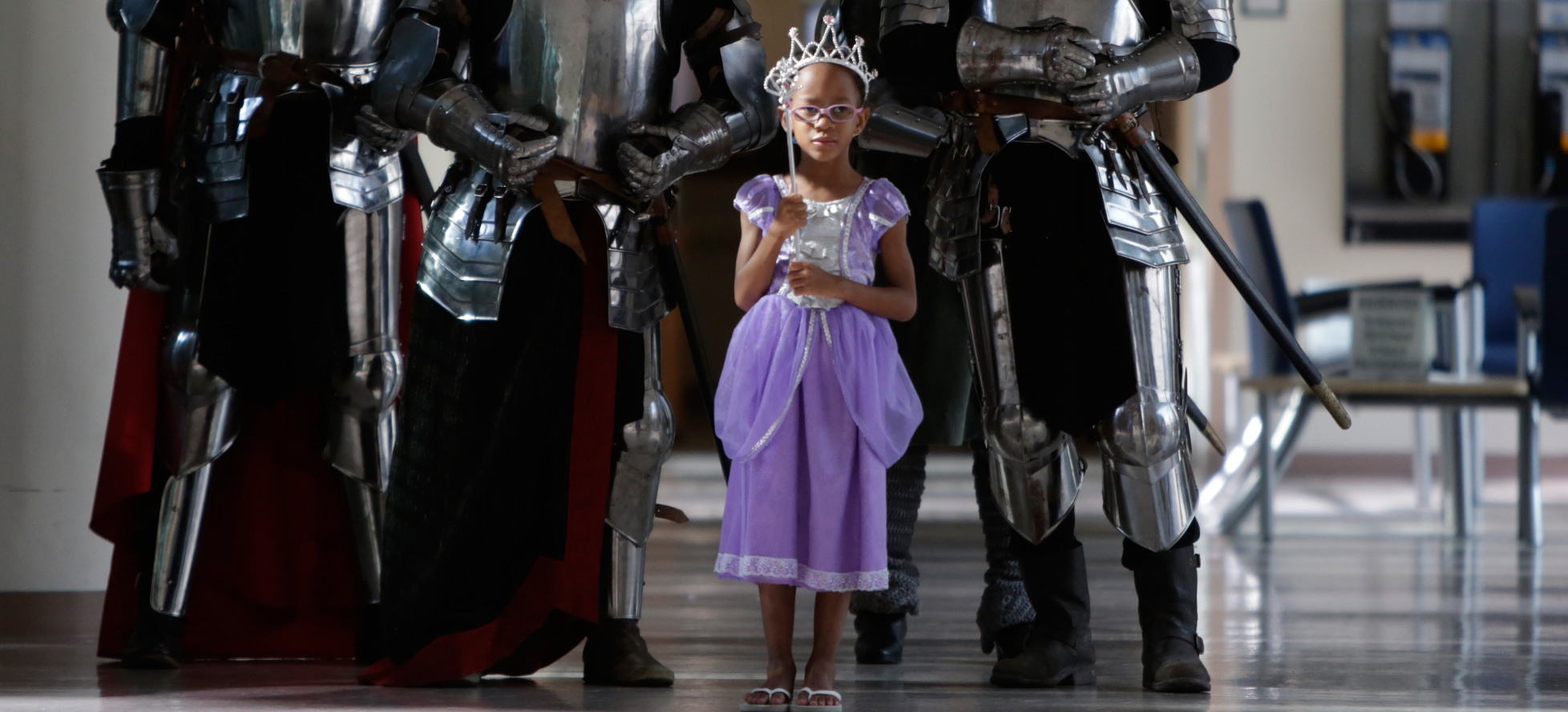little girl dressed as princess with knights