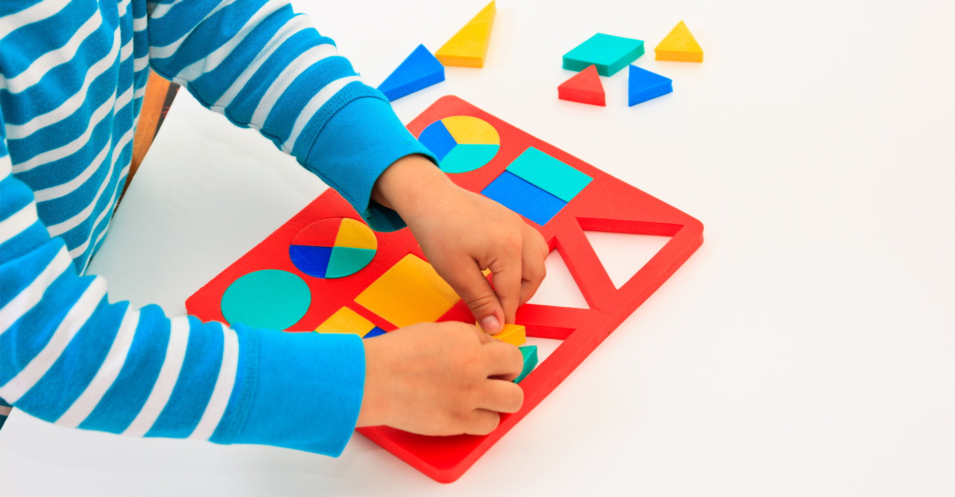 Kid playing with puzzle pieces
