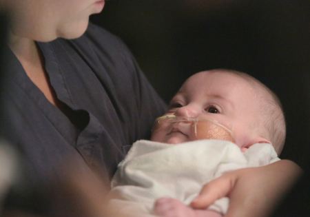 Baby being held by SickKids staff