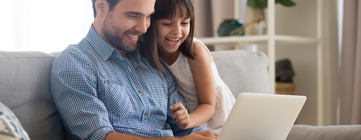 Father and Daughter viewing a screen