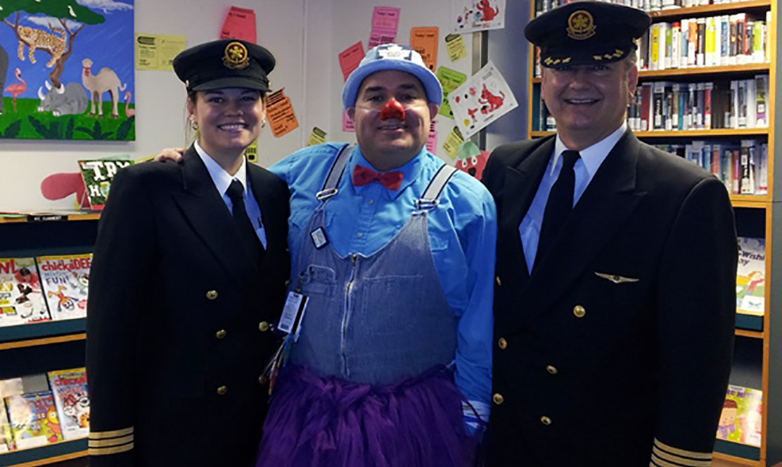 Therapeutic clown A. Leboo in the library at SickKids with 2 pilots
