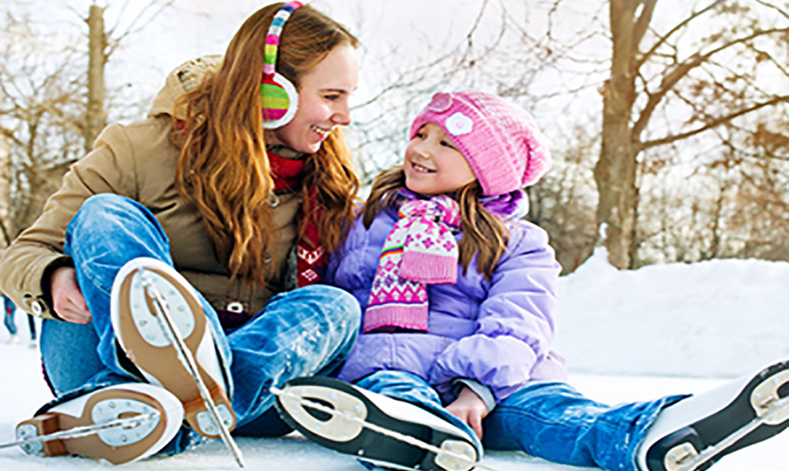 Mother and daughter wearing ice skates