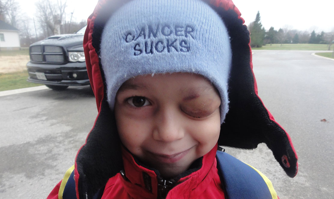 Little boy wearing cancer sucks toque
