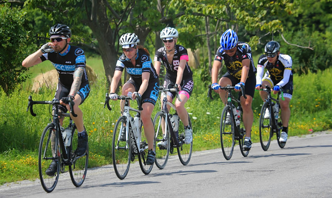 Cyclists riding bikes on road