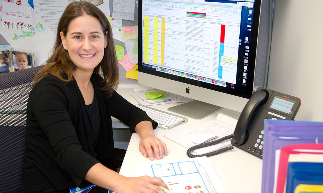 SickKids staff member sitting at a computer in her office