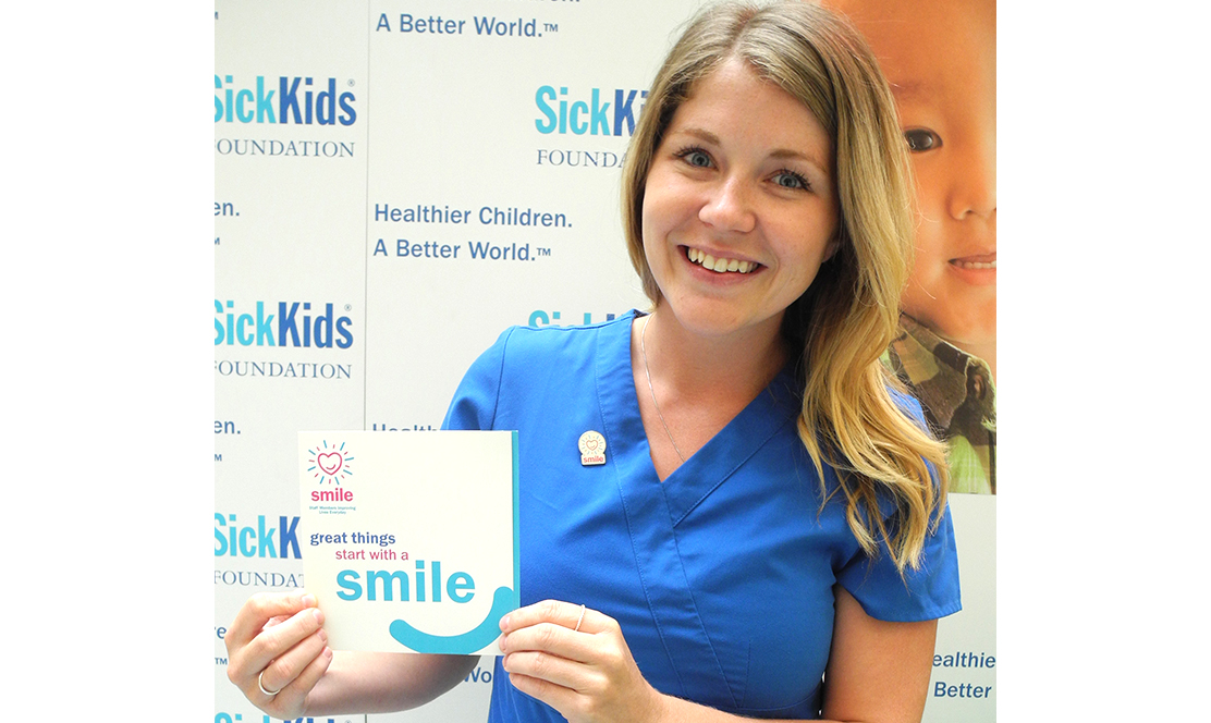SickKids staff holding SMILE card