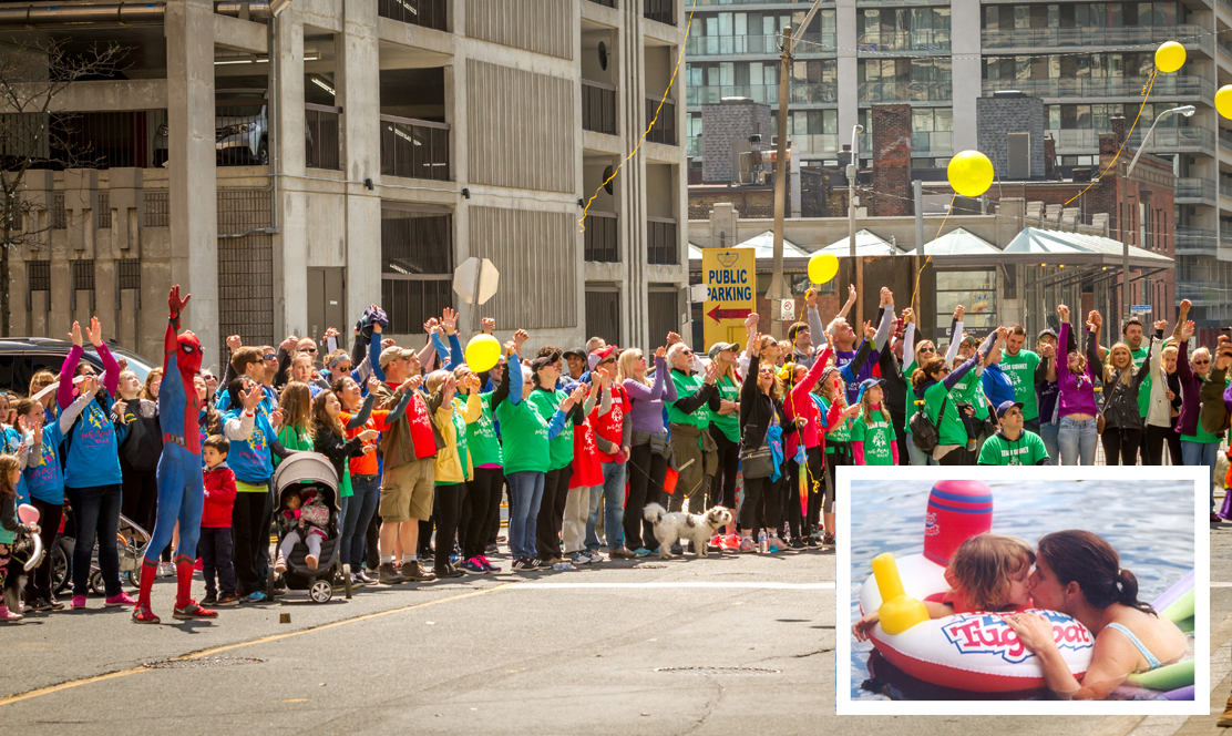 A large group of children and adults waving to patients in the hospital
