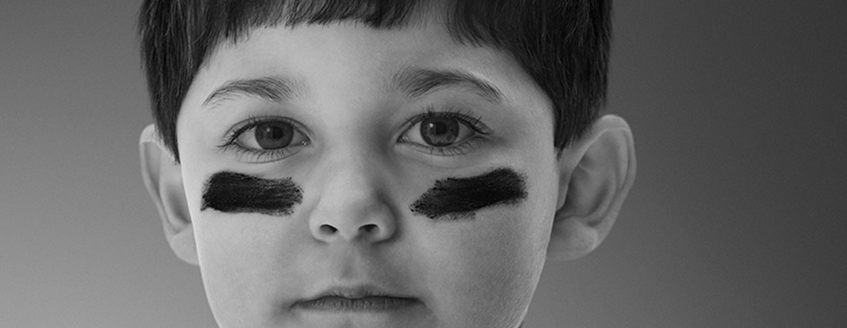 little boy with eye blacks