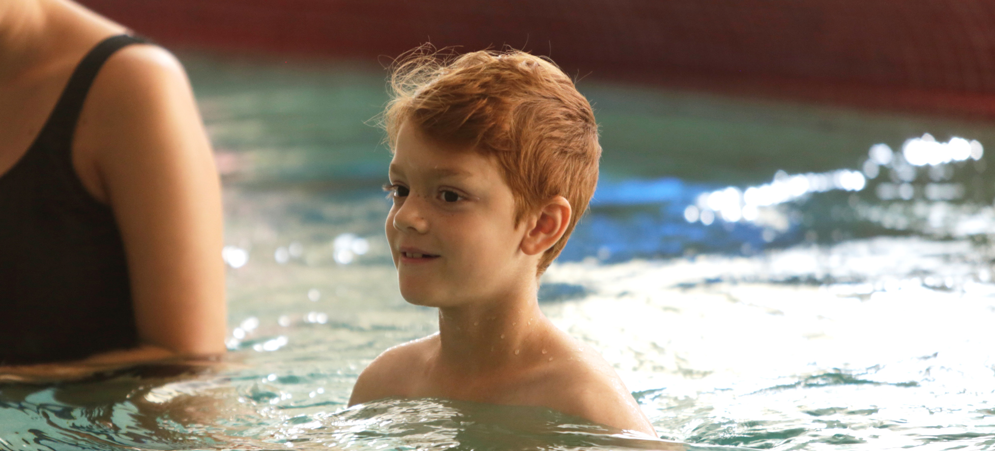 Redhead boy in swimming pool