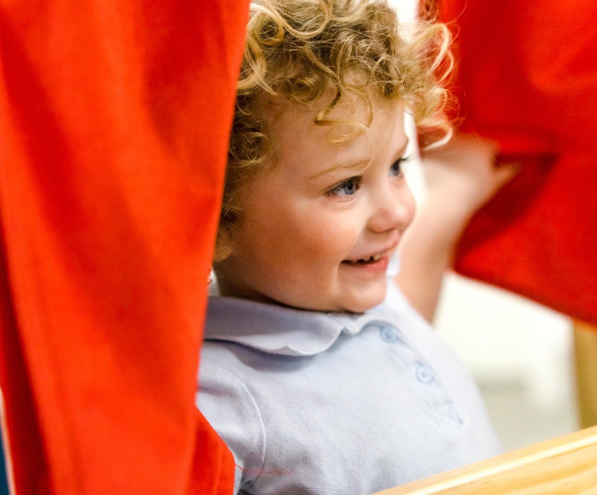 image of young girl with curly blonde hair smiling