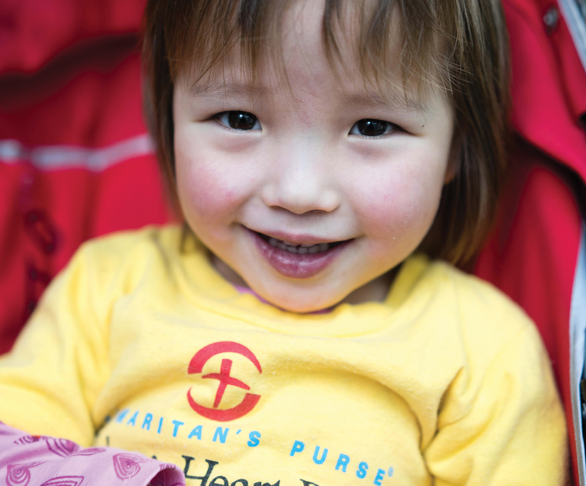 Little girl smiling in stroller