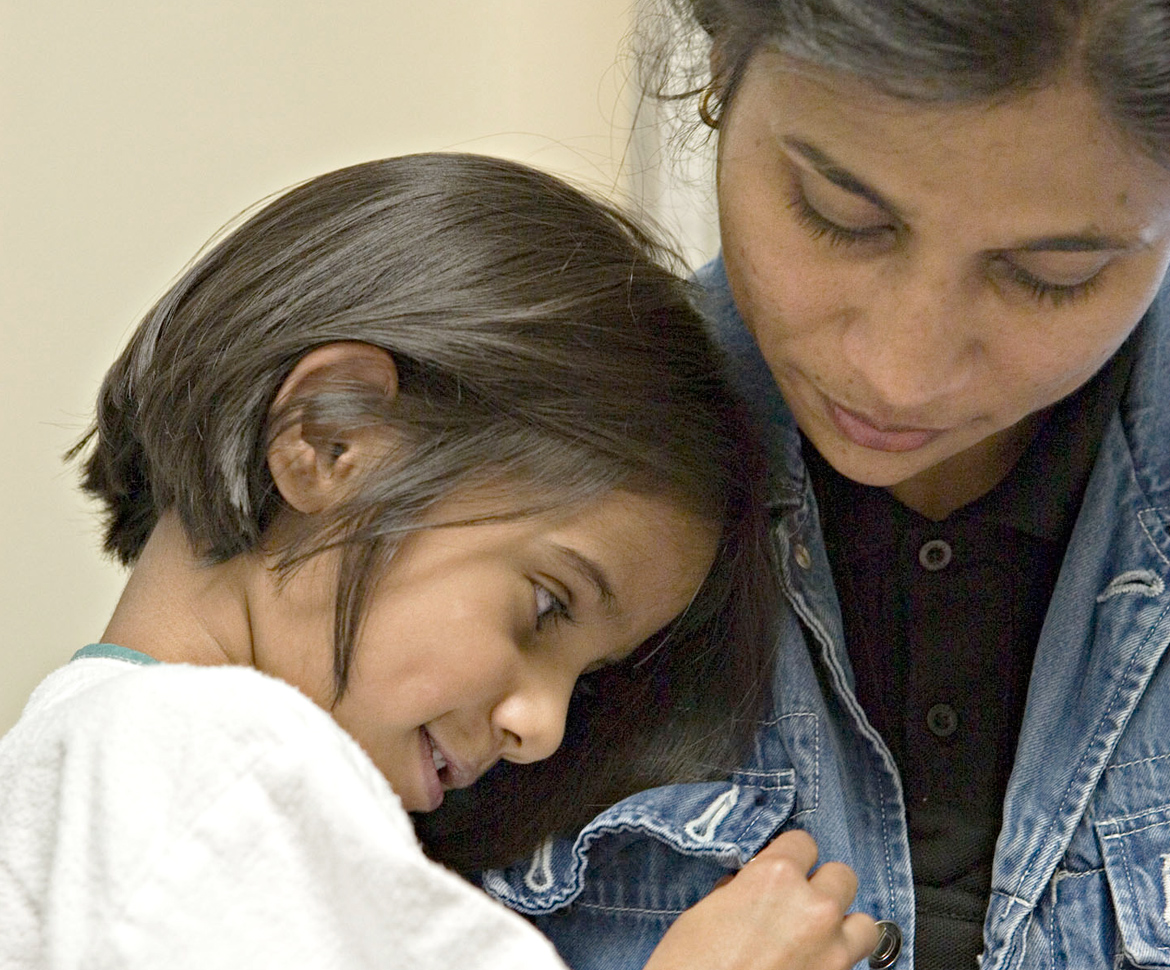 Girl hugging mom in jean jacket