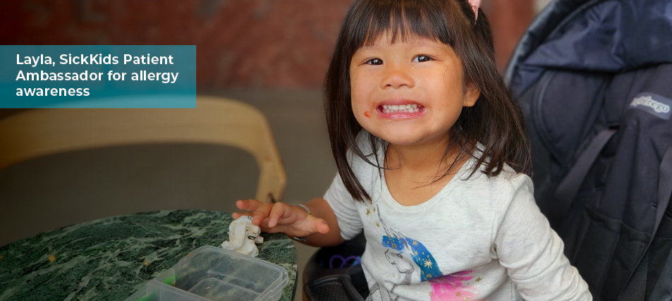 SickKids patient, Layla, smiling after finishing a snack