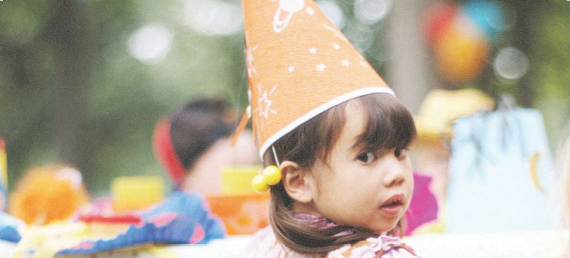 little girl with birthday hat