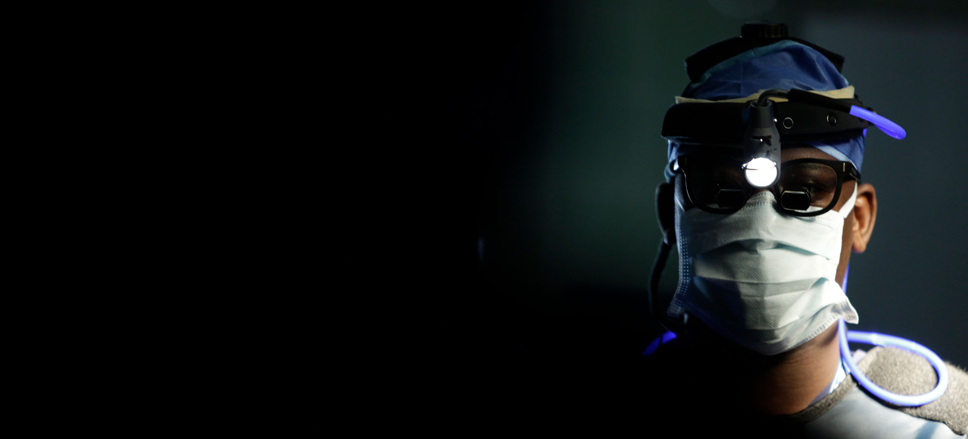 SickKids Doctor in scrubs with head lamp